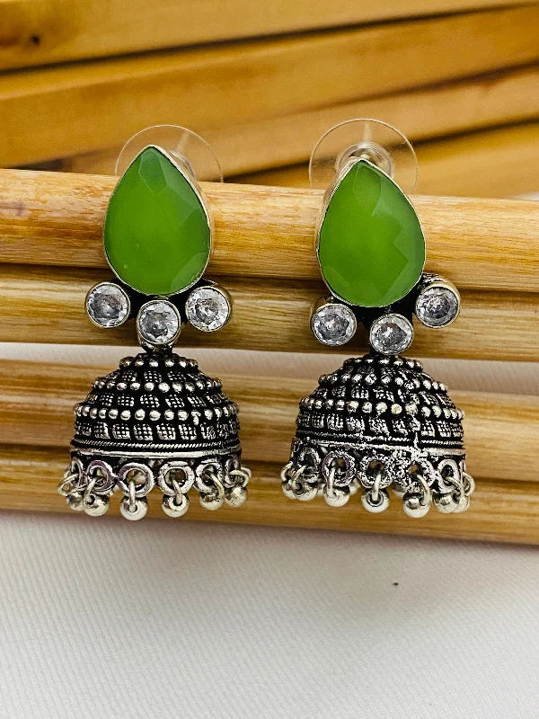 two-tone earrings for women -Lovely Green AD Stone Beaded Silver Toned Designer Jhumka Earrings With Black Pearl Drops